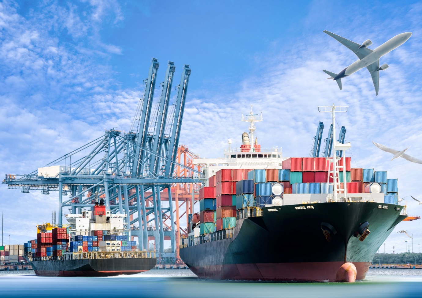 A large ship in the water with a plane flying over it